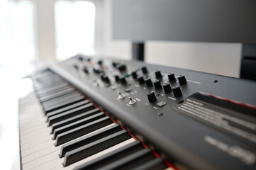 Closeup selective focus on keyboard of new electric synthesizer at shop showcase