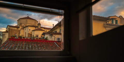 Window view of Firenze town skyline with houses and church at sunrise in the Metropolitan City of...