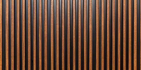 The surface of a brown wooden slatted panel. Decor and interior design, construction and renovation. Space for text. Panorama format. - obrazy, fototapety, plakaty