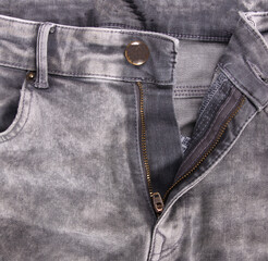 Worn grey jeans isolated, zipper open