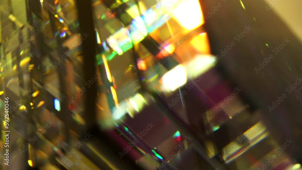 Poster rotating glass cube with colorful kaleidoscope effect by light reflection. abstract