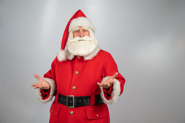 Portrait of an elderly man in a santa claus costume on a white background. 
