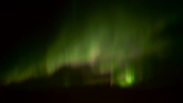Realtime videos of the northern lights in green, pink and orange colours with a clear dark starry sky in the background 