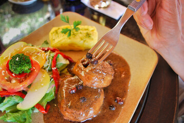 A person is eating a meal with a fork, Colombia's favorite food
