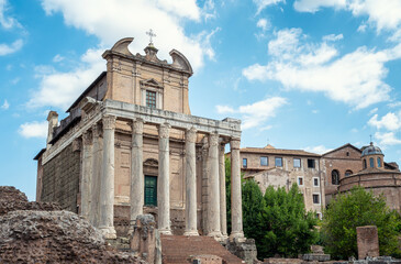 Fototapeta na wymiar Ruins of the Temple of Antoninus and Faustina - the front view of the San Lorenzo in Miranda church built inside the antique temple at the Sacred Road in Roman Forum in Rome, Italy