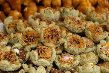 Various types or many colorful assortment of Turkish sweets for sale in street shop food festival. Baklava and pastries are sold on trays on the counter. Travel tourist attraction 