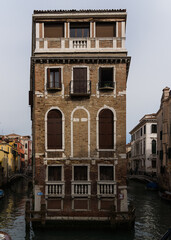 Fototapeta na wymiar Old iconic building in Venice, Italy in middle of two canals