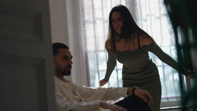 Girlfriend screaming and yelling at cold unresponsive boyfriend. Couple having relationship problems. Woman wanting man's attention