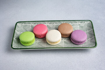 Pile of Macaroon or Macaron Biscuits on Grey Background
