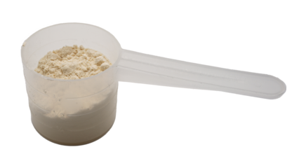 Whey protein powder in a measuring spoon isolated on white background.