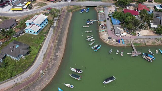 Aerial pan to left, traditional colourful asian fisherman village in Besut, Terengganu, Malaysia. 4K