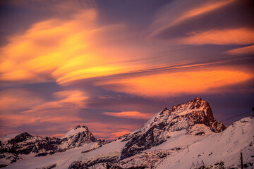 Naklejka na ściany i meble lenticular clouds over the swiss alps in zermatt during sunset