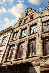 Fototapeta na wymiar Facades of medieval houses with tiled roofs in the center of Bruggegge