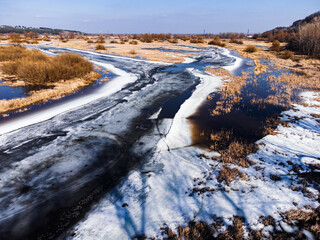 Aerial view of melting ice on the river in spring.
