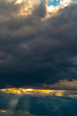 Beautiful dramatic sky with sunbeams through the clouds at sunset