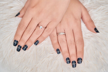 Close up view of a woman showing her hands with nail manicure. Manicure and beauty concept.