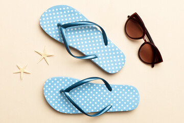 Summer travel concept. Flip flops, sunglasses and starfish on white. Top view on colored background - obrazy, fototapety, plakaty