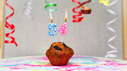 Happy birthday background with muffin with beautiful decorations with number candles  54. Colorful...