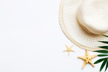 Fototapeta na wymiar Summer holidays. Summer concept with straw hat and tropical leaf. Flat lay, top view, copy space