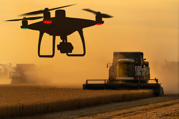 Silhouettes of combine harvester and drone	