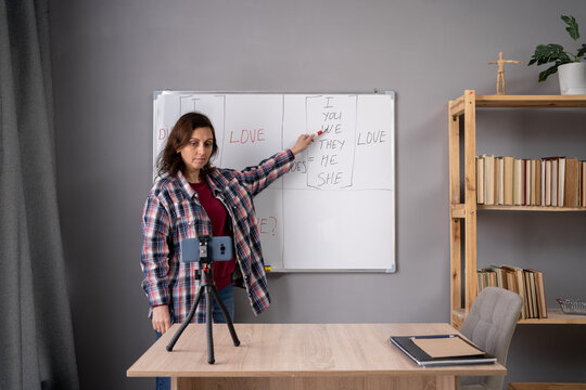 Female Teacher Teach English For Children Online Through Mobile Phone In Classroom At Home, Filming Educational Lecture. Talking Streaming Online, Video Blog Concept.