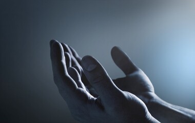 Pray hands open to the blue night sky