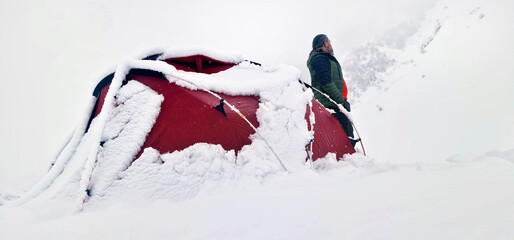 A man camping in the snow