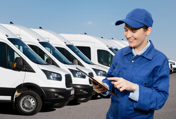 Manager with a digital tablet on the background of vans. Fleet management	