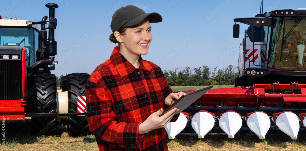 Poster farmer with digital tablet on a background of combine harvester and tractor. smart farming concept.