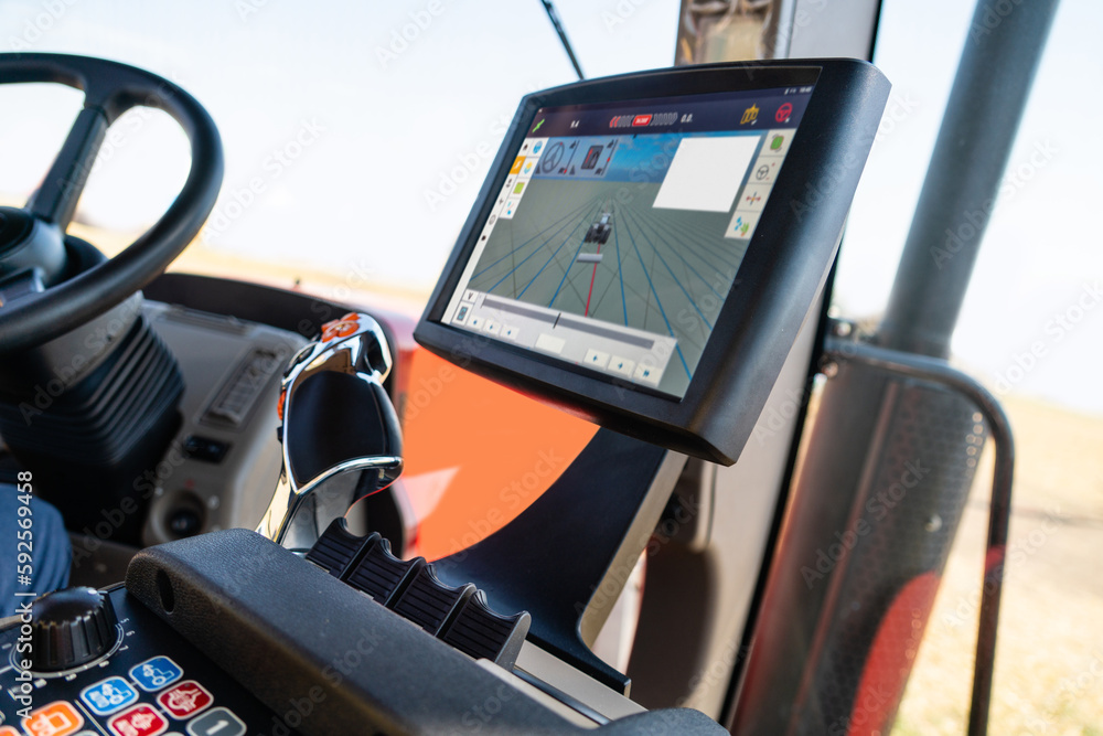 Aufkleber Cockpit of autonomous tractor working on the field. Smart farming