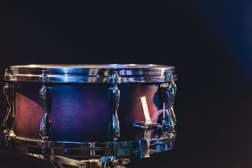 Fototapeta na wymiar Beautiful snare drum on a black background, close up.