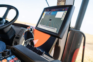 Cockpit of autonomous tractor working on the field. Smart farming