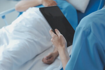 Injured patient showing doctor broken wrist and arm with bandage in hospital office or emergency room. Sprain, stress fracture or repetitive strain injury in hand. Nurse helping customer. First aid.