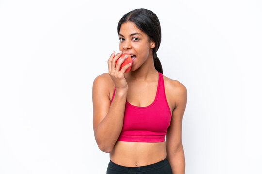 Young African american woman isolated on white background eating an apple