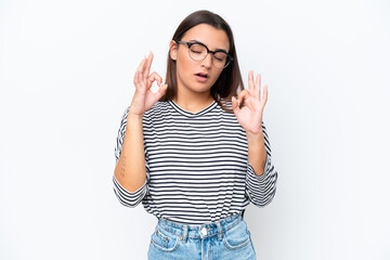 Young caucasian woman isolated on white background in zen pose