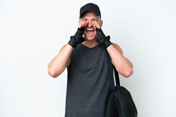 Young blonde sport caucasian man with sport bag over isolated white background shouting and announcing something