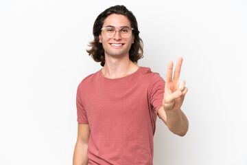 Obraz na płótnie Canvas Young handsome man isolated on white background smiling and showing victory sign