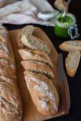 Fresh French home made Baguette Bread with wild garlic on dark background