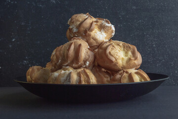 cookies and cake on a dark black background

