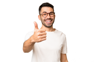 Young handsome caucasian man over isolated chroma key background with thumbs up because something good has happened