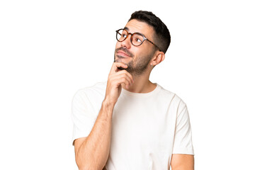 Young handsome caucasian man over isolated chroma key background and looking up