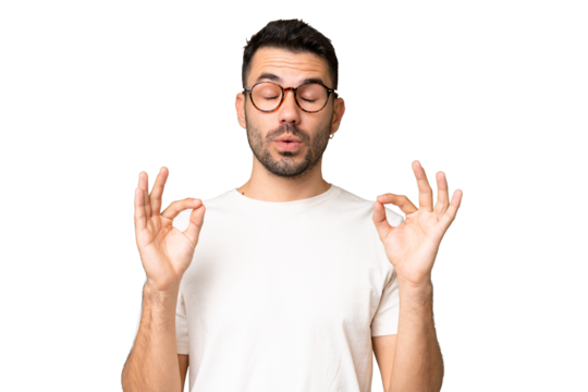 Young handsome caucasian man over isolated chroma key background in zen pose