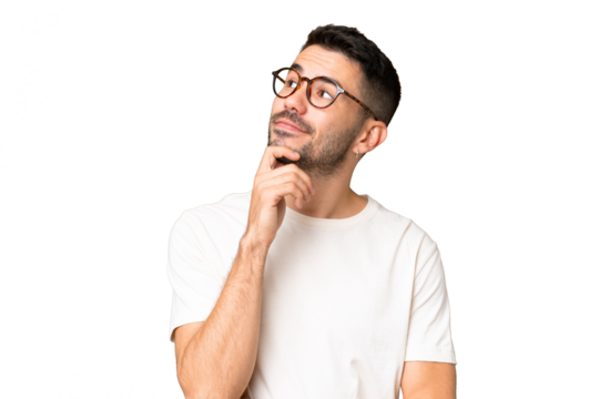 Young handsome caucasian man over isolated chroma key background and looking up