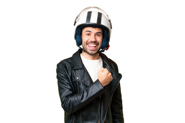 Young caucasian man with a motorcycle helmet over isolated chroma key background celebrating a...