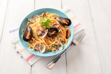 Deliziosi spaghetti conditi con cozze, vongole e bottarga, cibo italiano di mare 
