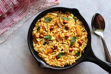 Jada Poha Namkeen Chivda or Thick Pohe Chiwda. Diwali special savory snack, made out of puffed rice, fried peanuts, curry leaves and some spices. Traditional Indian Diwali Snacks. with Copy Space.