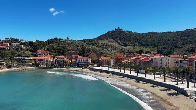 Tourists relax in the beach in the small village of Colliure, France.