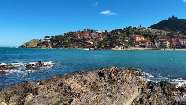 Tourists relax in the beach in the small village of Colliure, France.