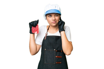 Butcher woman wearing an apron and serving fresh cut meat over isolated chroma key background frustrated and covering ears
