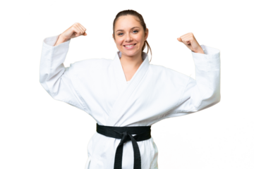 Young blonde woman over isolated chroma key background doing karate and making strong gesture